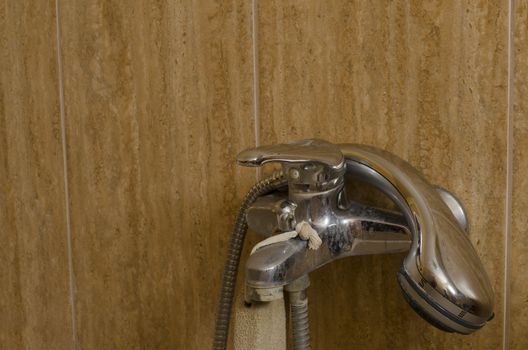 old calcified tap with shower in bathroom