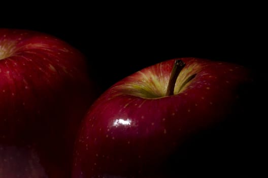 close-up of two apples on black background