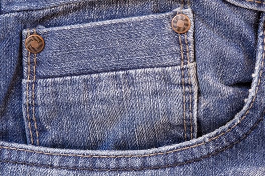 close up of a blue jeans pocket with two rivets