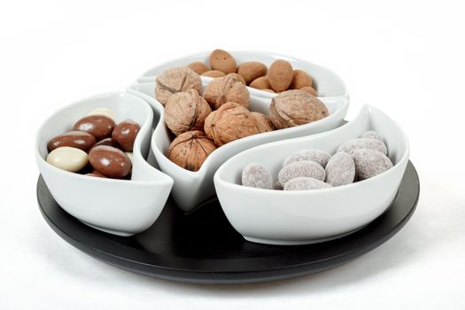 almonds in chocolate and walnuts on white background