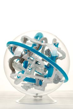 detail of 3D labyrinth ball, game on white background