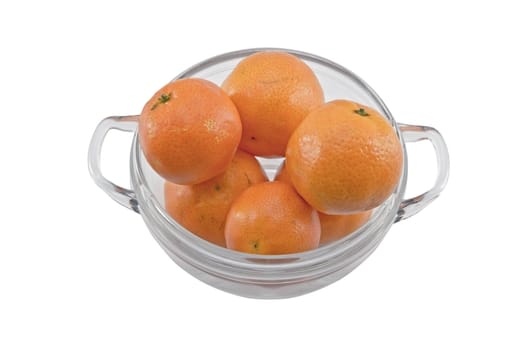 Oranges in a glass bowl isolated on white