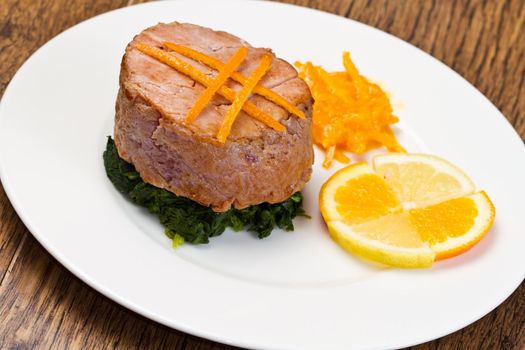 fried tuna fillet with fresh orange ,orange sauce and spinach