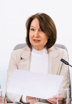 Portrait of a senior business woman, holds documents, communicates