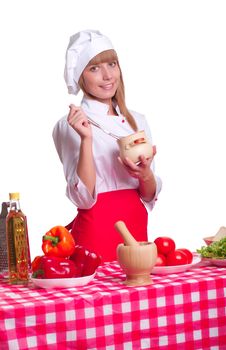 beautiful woman looking into a pot of food, cooking vegetables