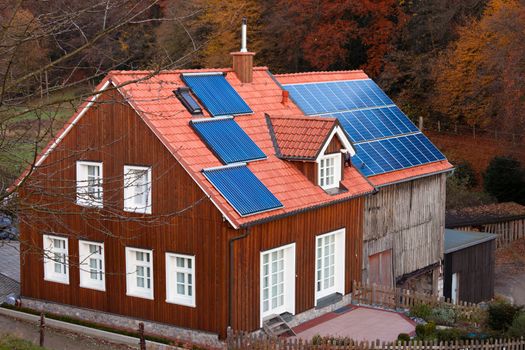 Historic farm house with modern solar electric and solar heating system on large roof.