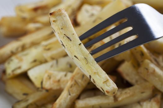 Cut roasted parsnips or potatoes with herbs.