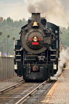 Steam engine waiting at train station