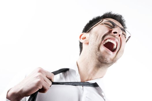 Young business man pulling his necktie and screaming, isolated on white