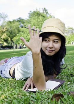 Asian college student studying outdoor in the park 