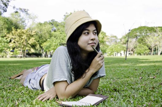 Woman thinking hard studying outside. Beautiful mixed asian / caucasian woman. 