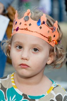 Wearing hand made orange paper crown during harvest festival.