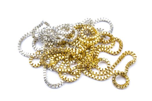 Silver and gold necklaces closeup on white