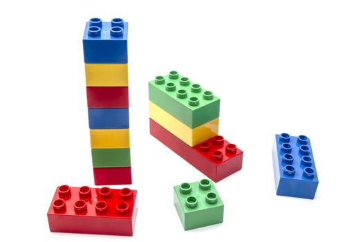 Colorful building blocks closeup on white background 