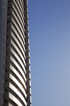 Perspective and underside angle view of modern glass building skyscrapers over blue sky 