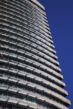 Perspective and underside angle view of modern glass building skyscrapers over blue sky 