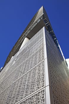 Perspective and underside angle view of modern glass building skyscrapers over blue sky 