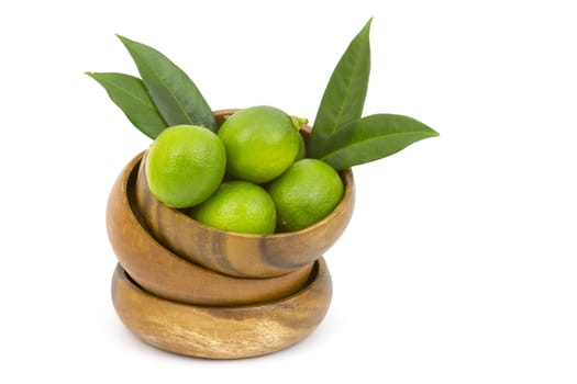 Wooden bowl filled with limes