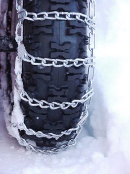 Snow chains outside at a wheel in winter