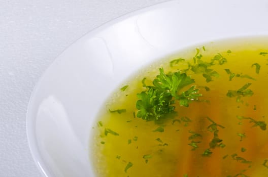 a fresh summery broth with leek onion, and carrot