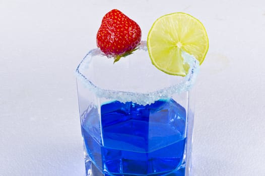 a composition with blue drink and strawberry