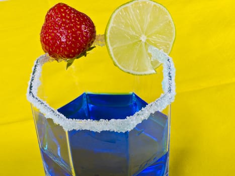 a composition with blue drink and strawberry