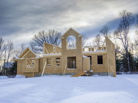 New house framing construction taking place in winter