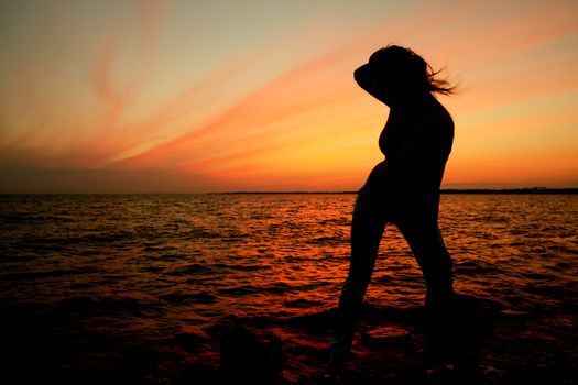 girl silhouette on sunset ocean view