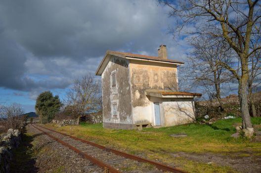 small house on the edge of the train tracks