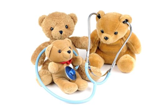 Three teddy bears and a stethoscope