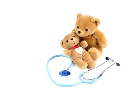 A stethoscope and two teddy bears