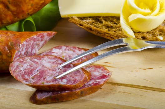 Tasty Polish sausage with bread, butter and vegetables