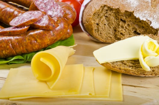 Tasty Polish sausage with bread, butter and vegetables