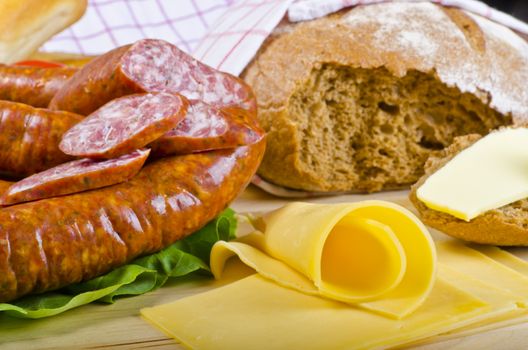 Tasty Polish sausage with bread, butter and vegetables