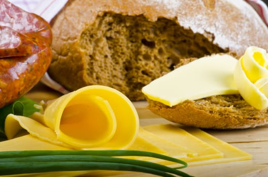 Tasty Polish sausage with bread, butter and vegetables