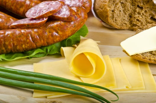 Tasty Polish sausage with bread, butter and vegetables