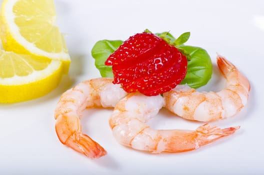 shrimp with strawberries and lemon on the plate