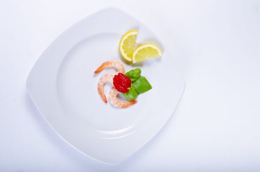 shrimp with strawberries and lemon on the plate