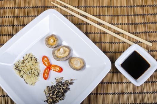 Rice and mushroom and Shiitake has young zwibel on plate with Mu Err