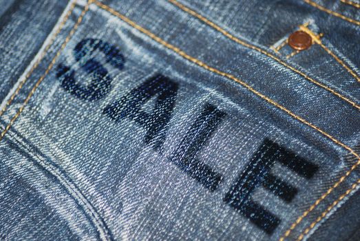 Closeup of Sale Sign on Back Pocket of Blue Jeans