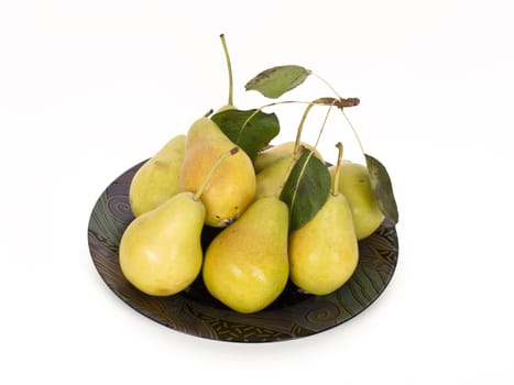 fresh pears on plate with foliage