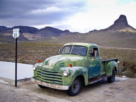 ROUTE 66, ARIZONA/USA - DECEMBER 30: Vintage green Chevrolet truck with Route 66 sign at gas station shown on December 30, 2012 in Arizona's historic Route 66