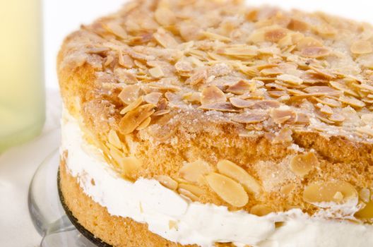 flat cake with an almond and sugar coating and a custard or cream filling