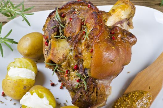 Roasted pork knuckle. Ham and bacon are popular foods in the west, and their consumption has increased with industrialisation.