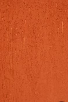 Red painted plastered house wall as background