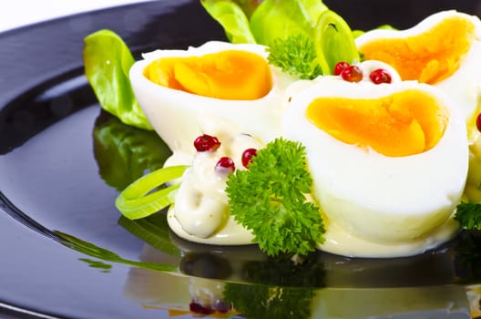 Boiled eggs are eggs (typically chickens' eggs) cooked by immersion in boiling water with their shells unbroken.