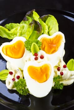 Boiled eggs are eggs (typically chickens' eggs) cooked by immersion in boiling water with their shells unbroken.