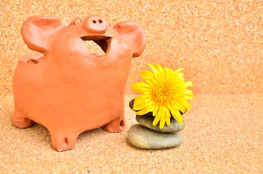 One Pig statues laugh near flower .