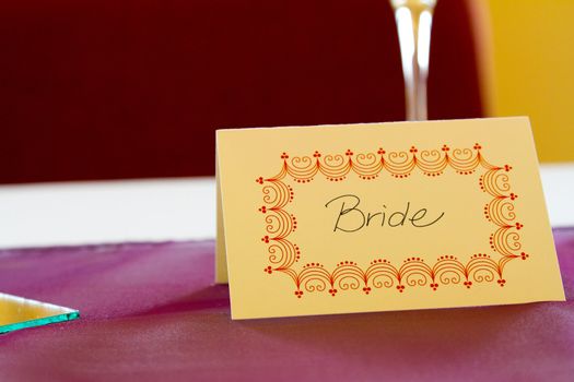 This name tag says bride to reserve her spot at a wedding dinner table.