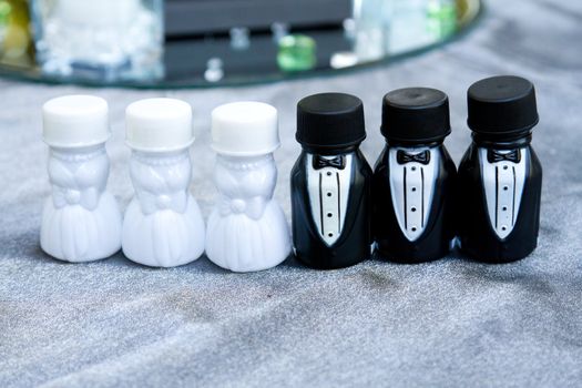 These party favors are containers of bubbles at a wedding. The photographs here represent the bridal party lined up together.